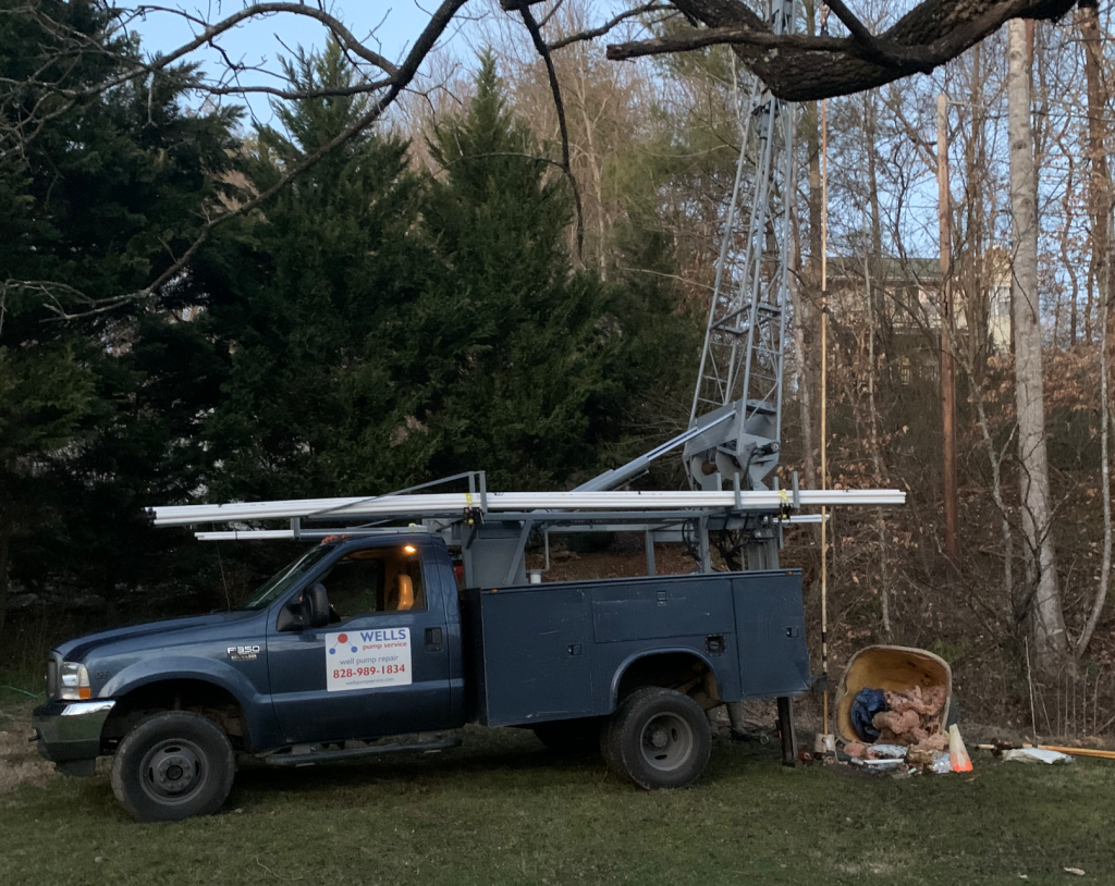 An image of the Wells Pump Service truck doing well pump service